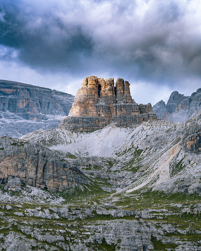 High mountains in the Dolomites. Italy. Alps. Famous tourist place. Dark gray sky. Light rocks.